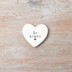 A mini porcelain heart shaped token with encouraging words.