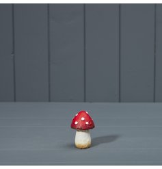 A miniature red polkadot mushroom decoration. 