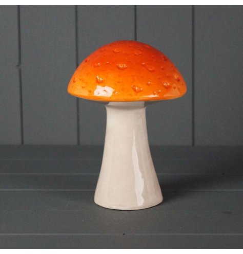 A simple yet stylish mushroom ornament in burnt orange with a textured detail and a simple glaze finish