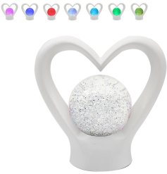 This beautiful white heart shaped lamp is perfect for adding a touch of romance to any room. 