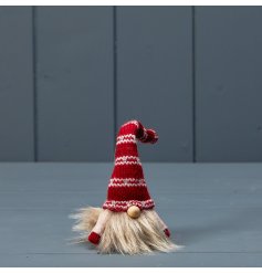 A traditional gonk decoration with a charming knitted hat in rich Christmas colours with a simple fairisle pattern. 