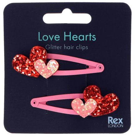 A set of 2 pretty hair clips in pink with a glitter love heart decal.