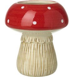 A medium sized planter in a red toadstool shape.