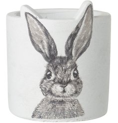 A gorgeous white decorative pot with a brushed bunny rabbit design.