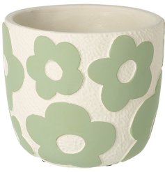 This small planter is the perfect addition to any home. With its dainty green flowers