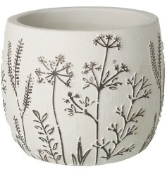 A white textured pot with an embossed floral finish. 