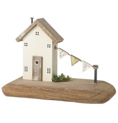 A charming country cottage house with ditsy floral flags and hand painted details. Complete with driftwood base.