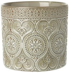 A decorative ceramic pot with a green wash glazed. Beautifully ornate and perfect for an array of house plants