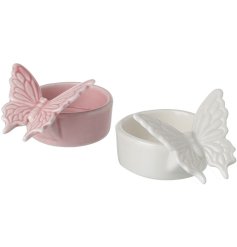 A dainty t - light holder in a butterfly design.