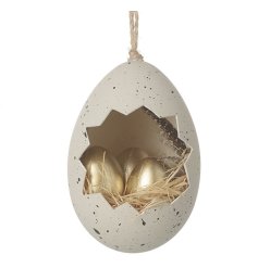 A chic speckled egg decoration with a nest of golden eggs displayed inside. Complete with jute string hanger.