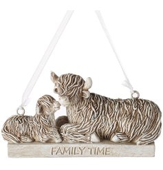 A  highland cow parent and child hanging ornament featuring cream and brown hues with 'family time' text. 