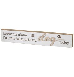 An off white wooden plaque featuring scripted text and 3D 'dog' wording.