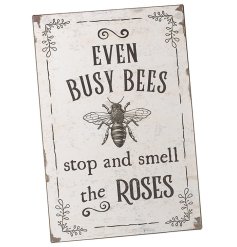 Even busy bees stop and smell the roses. A rustic metal sign with a charming bee slogan and vintage illustration. 