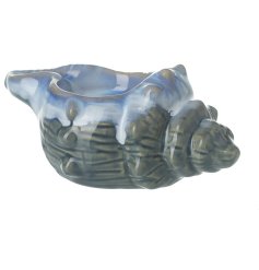 A conch shell t light holder in a 2 tone blue colour finished with a simple glaze.