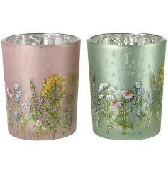 2 assorted t light holders in green and pink adorned with tiny flower details.