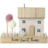 A shabby chic home decoration featuring a polkadot pattern house with a picket fence and bike detail and two pom pom tre