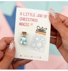A pocket sized jar filled with mini snowflakes, backed onto matching card with the wording 