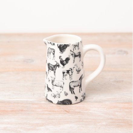 A black and white jug covered in realistic images of farmyard animals. 