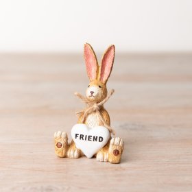 A charming sitting rabbit decoration with a rustic jute string bow and Friend heart detail.