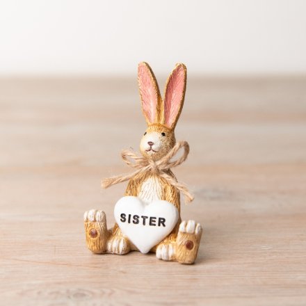 A charming sitting rabbit decoration with a heart shaped sister sentiment detail. 