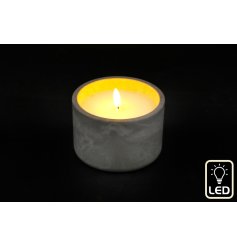 A simplistic cement candle pot featuring a single led flame with cosy warm white tones. 