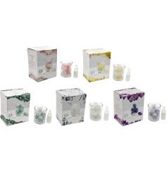 A pure relaxtion gift set. Featuring a glass pot filled with crystals containing different properties and a scented oil.