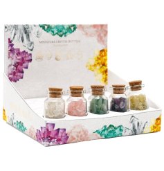 A spiritual assortment of 5 glass bottles each containing a collection of mini crystals, each with their own properties 