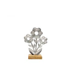 A simple yet stylish flower made from aluminium, set on a wooden base.