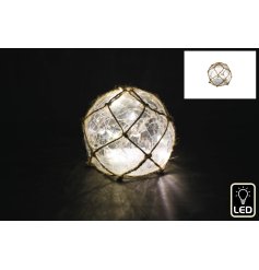 A jute covered decorative ball lit by LED's in a warm white tone.