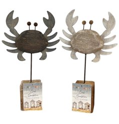 A rustic wooden crab ornament finished with a whitewash effect, mounted on a pole with a chunky base. 