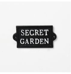 A dainty black sign with ' Secret Garden' text in white. 