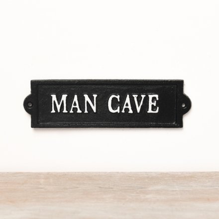 A black iron wall sign with white 'Man Cave' text. 