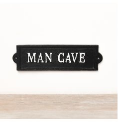A black iron wall sign with white 'Man Cave' text. 