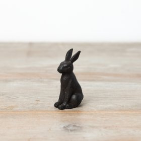 A cast iron rabbit perfectly sat made from cast iron. 