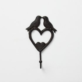 A rustic wall hook featuring two love birds above a heart design, 