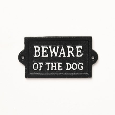 A rustic cast iron sign in black with 'Beware of the dog' text printed in white. 