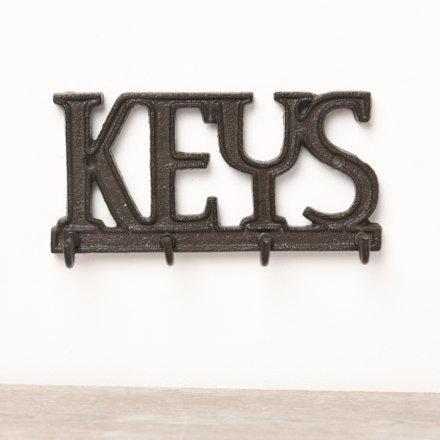 A rustic cast iron key sign with 4 key hooks. 