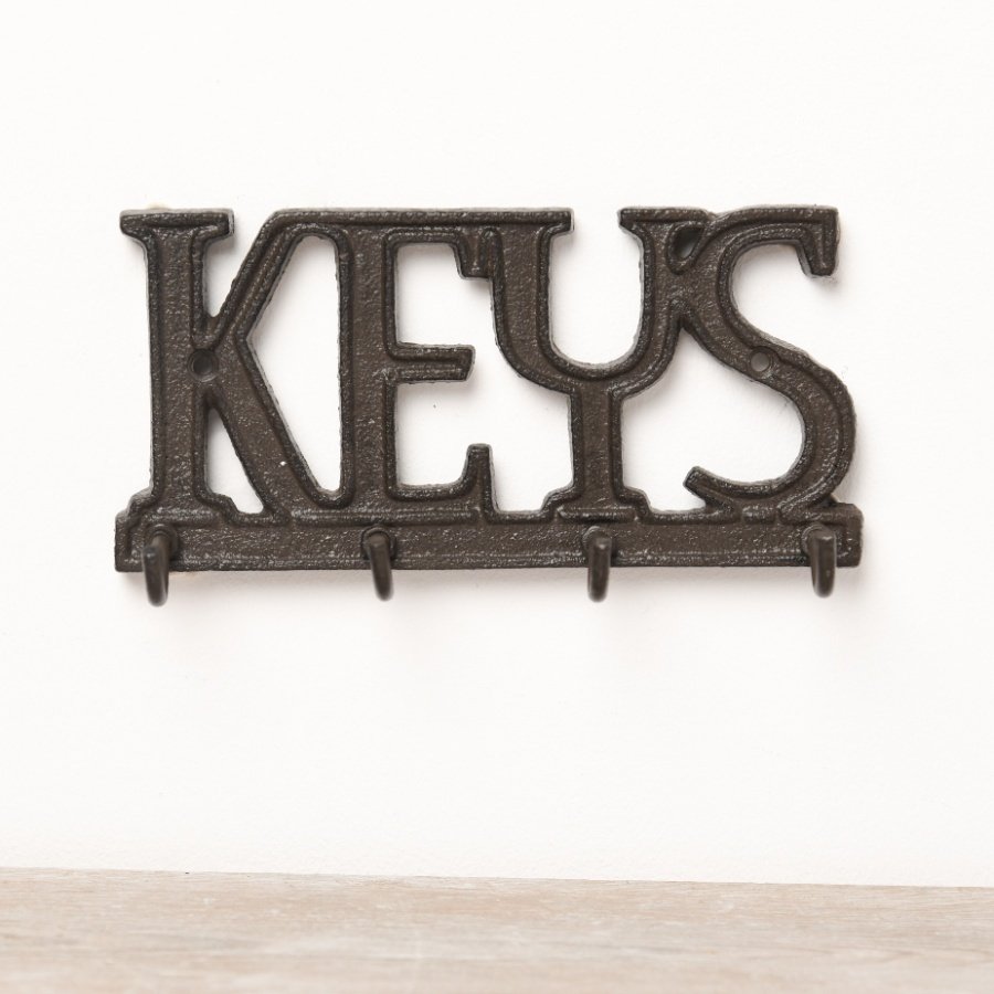A rustic wall sign with 'keys' wording and 4 key hooks. 