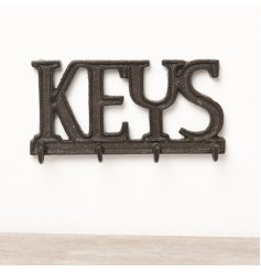 A rustic cast iron key sign with 4 key hooks. 