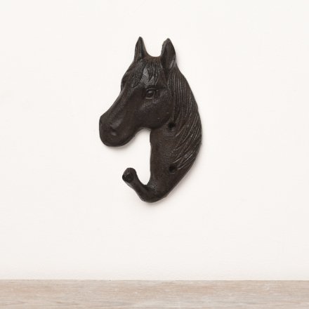 A black cast iron hook with a horse design. 