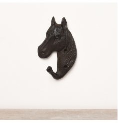 A black cast iron hook with a horse design. 