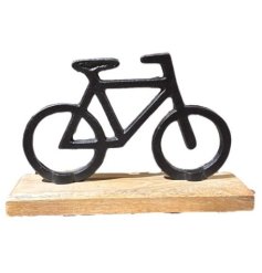 A simplistic black bicycle ornament set on a natural wood base.