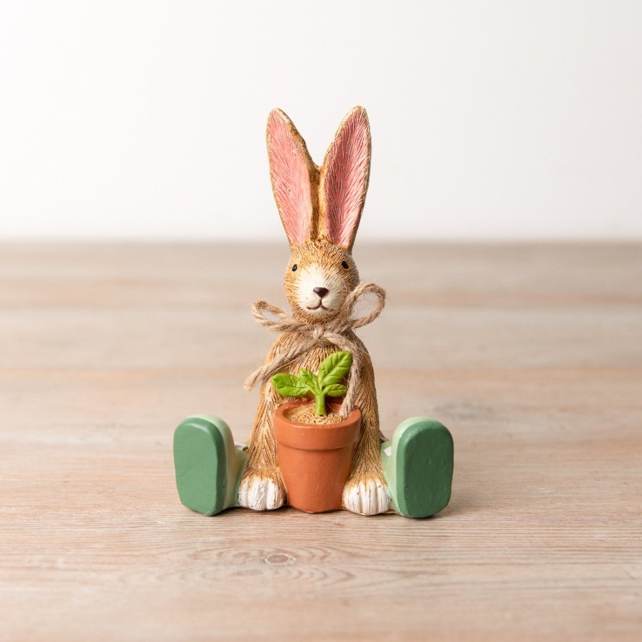 An adorable sitting bunny decoration with green wellington boots and a rustic jute bow. A must have garden themed gift. 