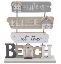 A tall freestanding wooden plaque featuring tiered wooden posts with 'life is better at the beach' wording