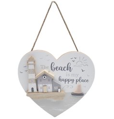 A coastal heart shaped wooden plaque hung by jute twine. 