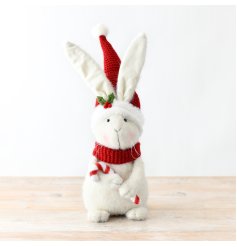 A snowy white fabric bunny with a festive hat and a vibrant red scarf.