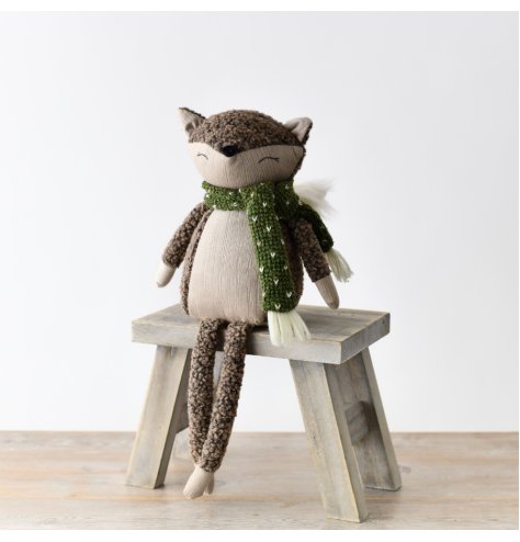 A delightful seated fox crafted from fabric, with long legs and a fluffy tail