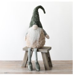 An whimsical woodland sitting gonk in sage green.