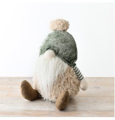 A sweet sage green fabric gonk with striped arms and a bobble hat.