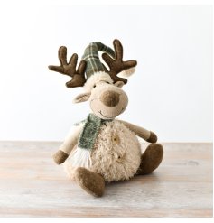 An adorable sitting moose decoration featuring an on trend green and tartan details and a fluffy body. 